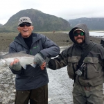 Silver salmon caught on tidal flat in front of camp